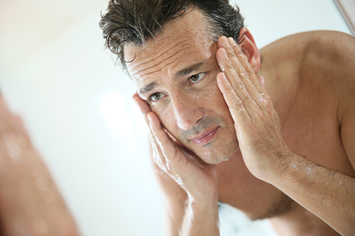 Man washing his face